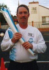 Kevin Mansell with Olympic Torch